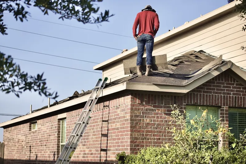 Professional roofer working on a residential roof in Belleview